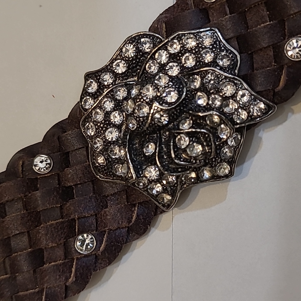 Leather bracelet with rose Rehninstones on it. 1 1/2 inches wide and 8 1/2 lengt